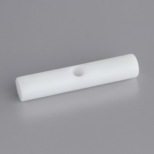 A white plastic tube with a hole.