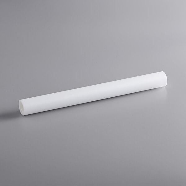 A white tube with a long end on a gray surface.