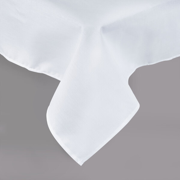 A close-up of a white Intedge rectangular tablecloth with a folded edge.