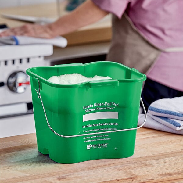 A green San Jamar Kleen-Pail Pro bucket with white text on the side.