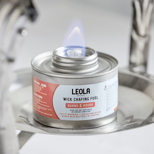 A Leola Fuel can with a flame on it sitting on a table.