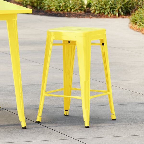 Lancaster Table & Seating Alloy Series Citrine Yellow Outdoor Backless Counter Height Stool