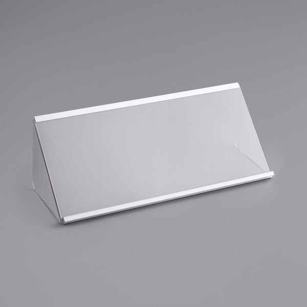 A white rectangular lid with a clear surface on a gray surface.