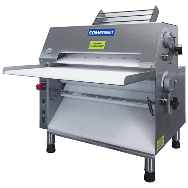 A Somerset countertop dough sheeter with a stainless steel top.