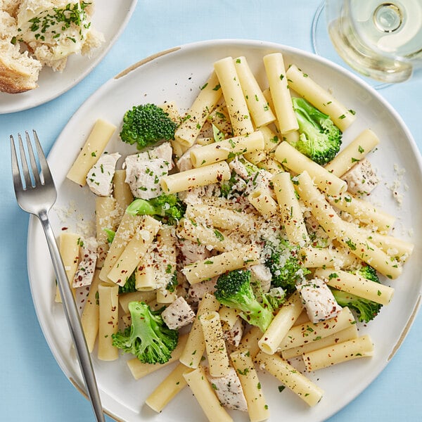 A plate of Barilla Cut Ziti pasta with broccoli and chicken.