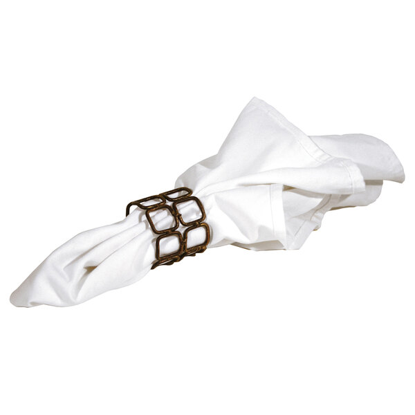 A white napkin with a copper metal link napkin ring on it.