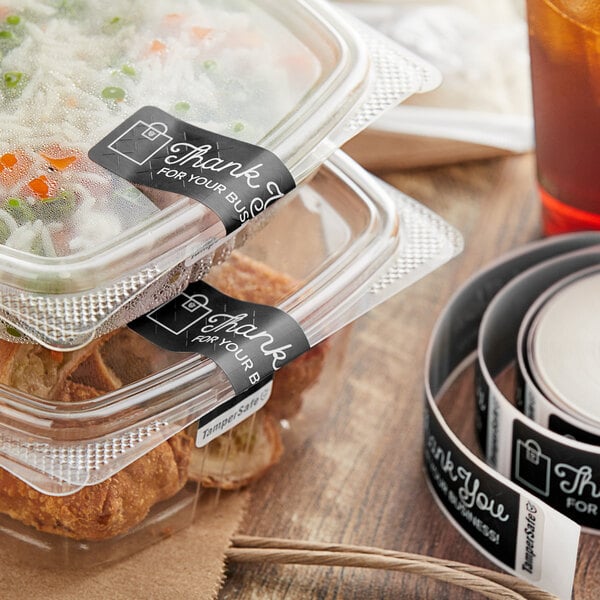 A plastic container of food with a black TamperSafe label on it.