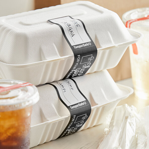 A stack of styrofoam food containers with a black TamperSafe label.
