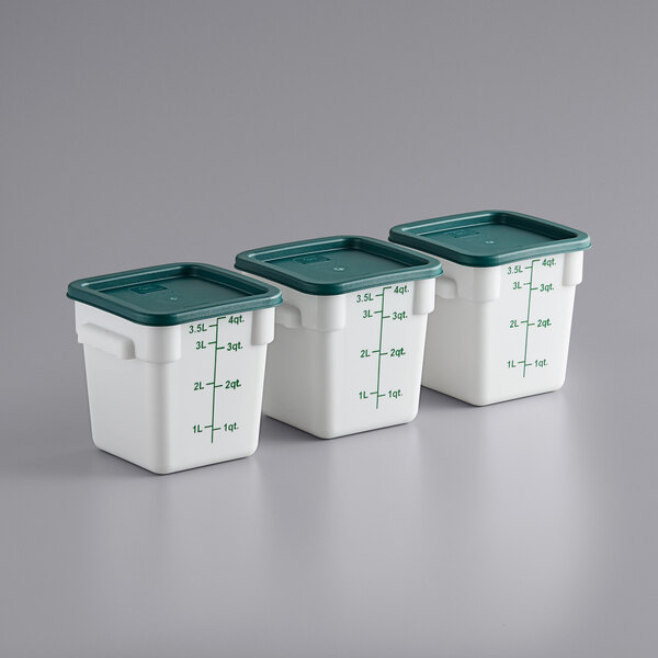 A row of Choice white polypropylene food storage containers with green lids.