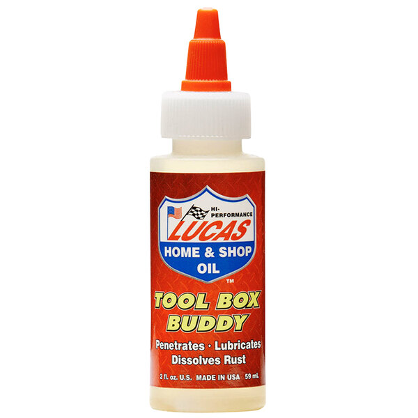 A bottle of Lucas Oil Tool Box Buddy Lubricant on a table.