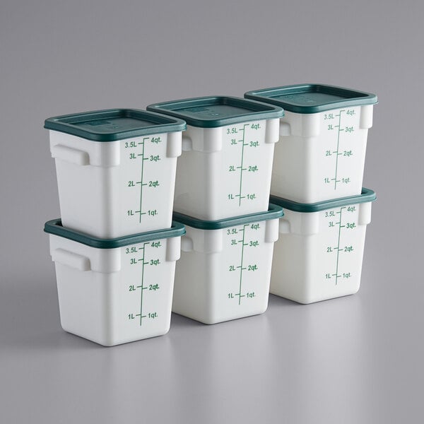 A stack of white Choice square polypropylene food storage containers with green lids.