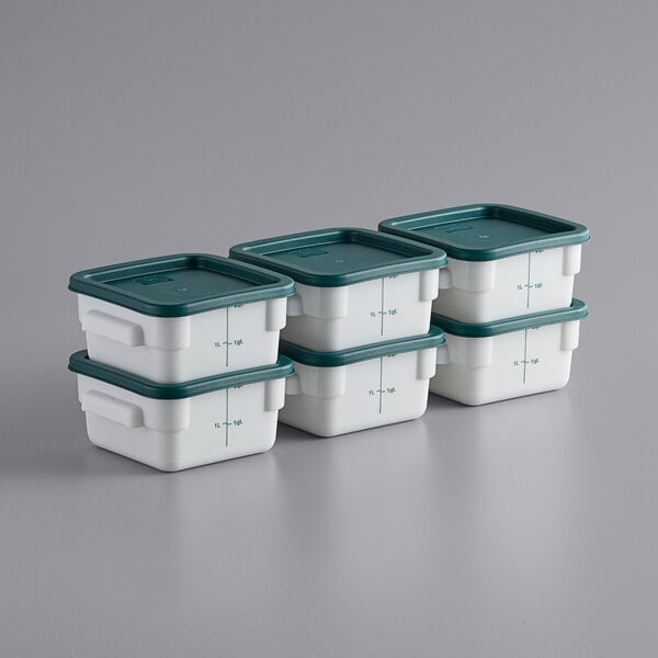 A stack of Choice white square plastic food storage containers with green lids.