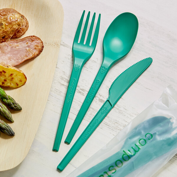 A plate of food with EcoChoice green plastic utensils.