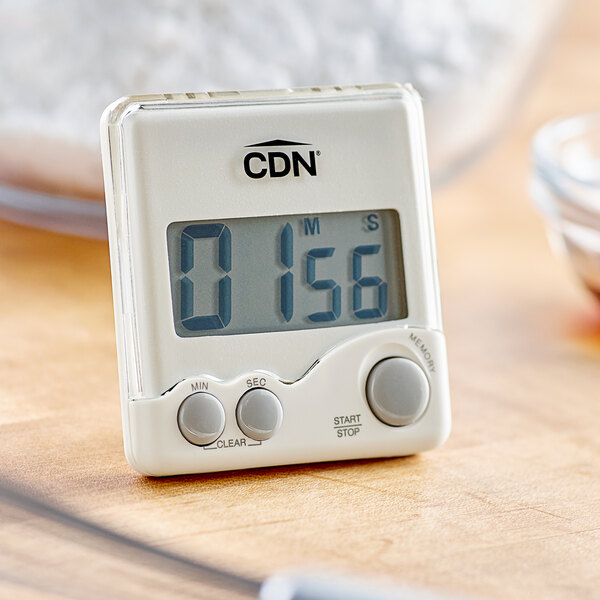 A white CDN digital kitchen timer on a table.