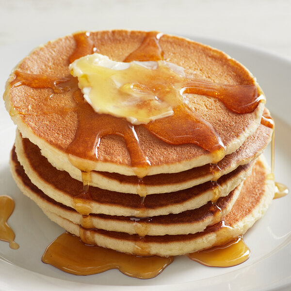 A stack of pancakes made with Bob's Red Mill 10-Grain Pancake and Waffle Mix with butter and syrup on top.