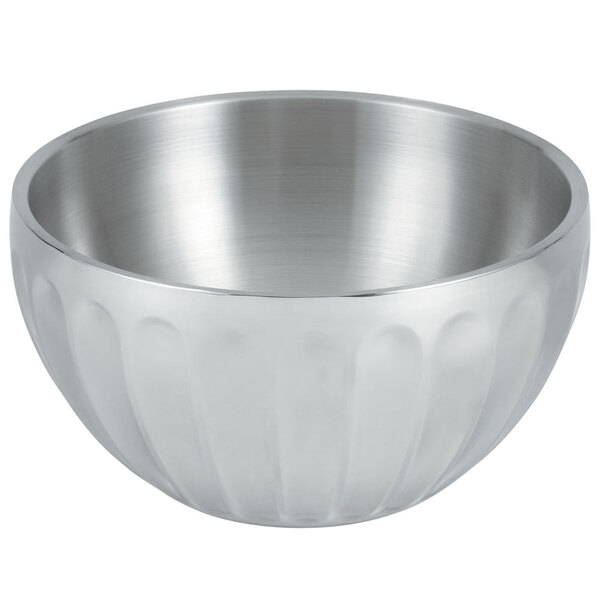A silver Vollrath fluted serving bowl with a curved design.
