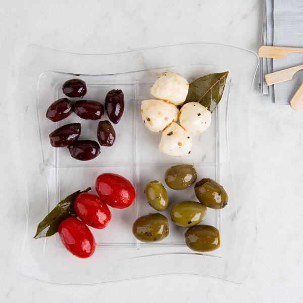 A Fineline clear plastic tray with olives and cheese on it.