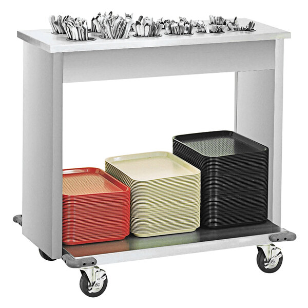 A Vollrath stainless steel cart with trays and flatware on it.