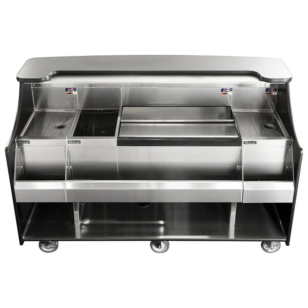 A Perlick stainless steel mobile bar with sink and ice chest on a counter.