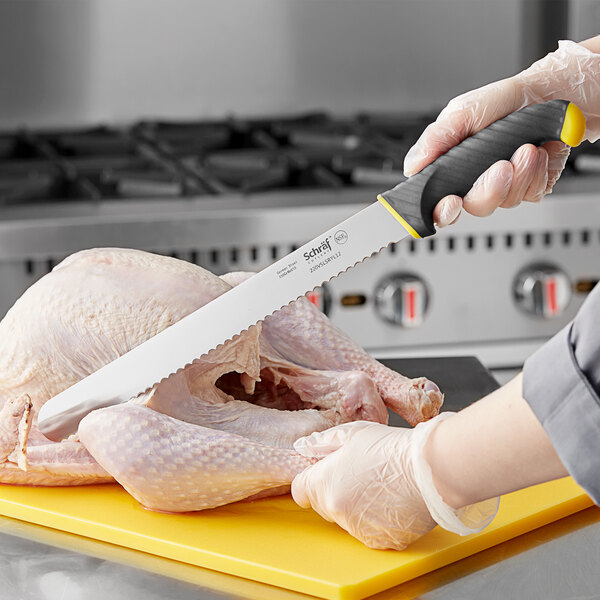 A person using a Schraf serrated slicing knife to cut a chicken.
