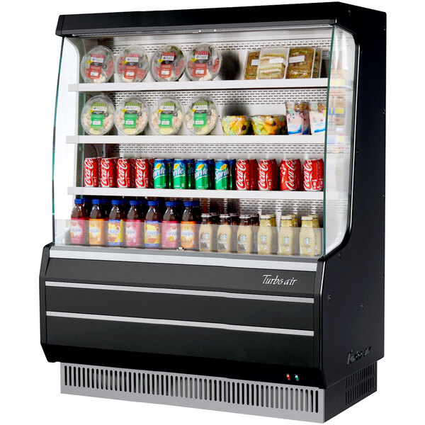 A black Turbo Air refrigerated display case with drinks and beverages.