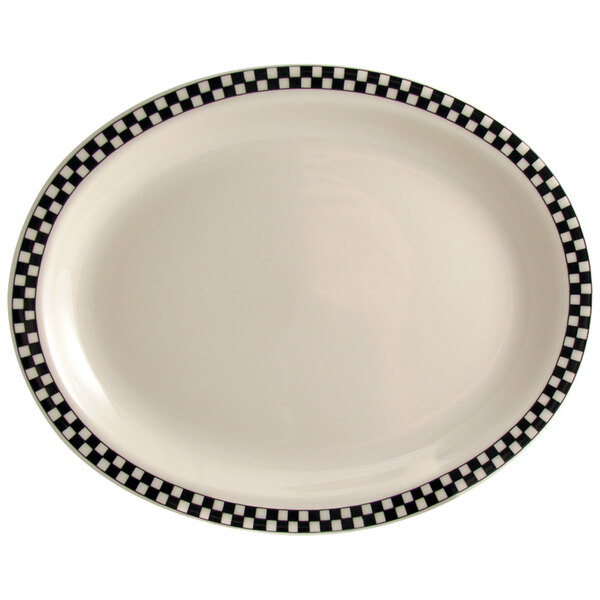 A creamy white china platter with black and white checkered trim.