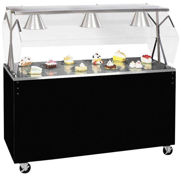 A black and silver Vollrath portable buffet cart with a clear cover over cupcakes on top.