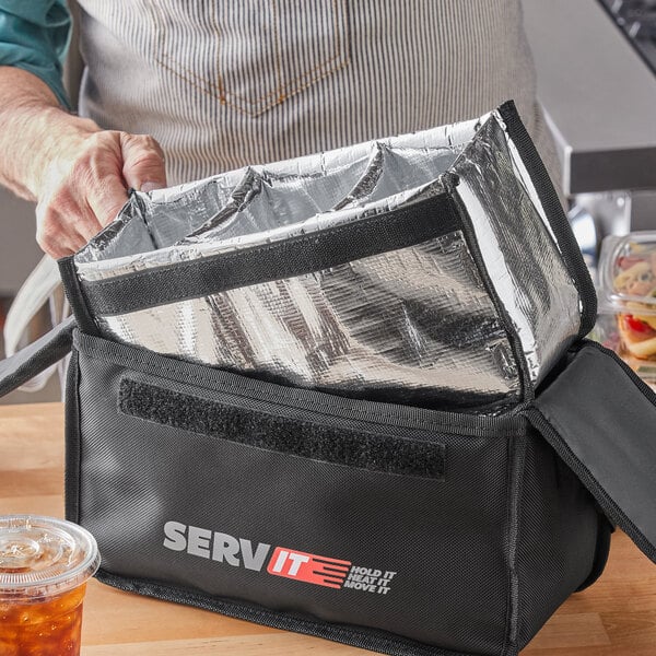 A man holding a ServIt drink bag with 3 plastic cups inside.