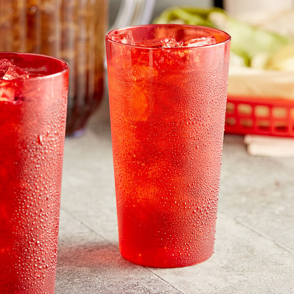 Two red Choice plastic tumblers filled with ice and water.