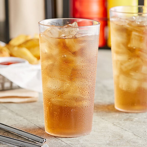 Two Choice clear plastic tumblers filled with ice tea on ice.