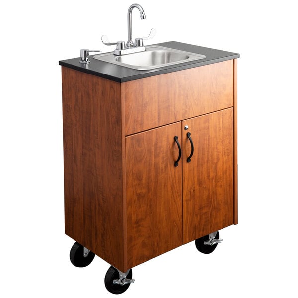A Bon Chef portable hand washing station with a cherry wood finish.