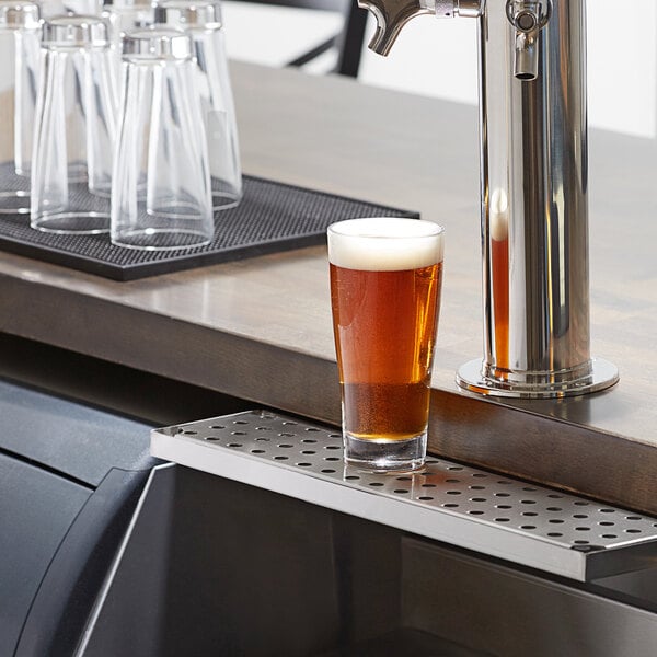 An 18" stainless steel beer drip tray under a beer tap on a counter.