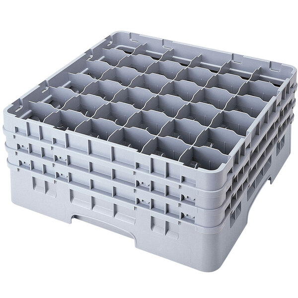A stack of plastic containers with white plastic Cambro glass racks inside.