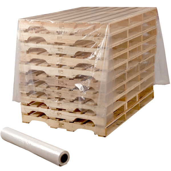 A stack of wooden pallets covered in clear plastic sheeting.