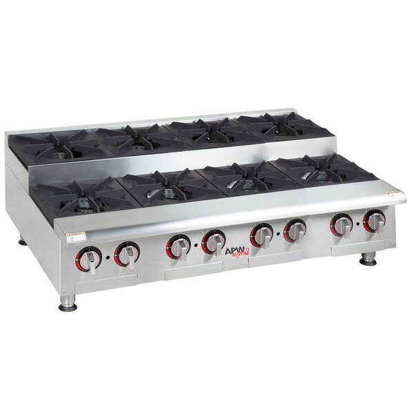 An APW Wyott countertop gas range with eight burners and black knobs.
