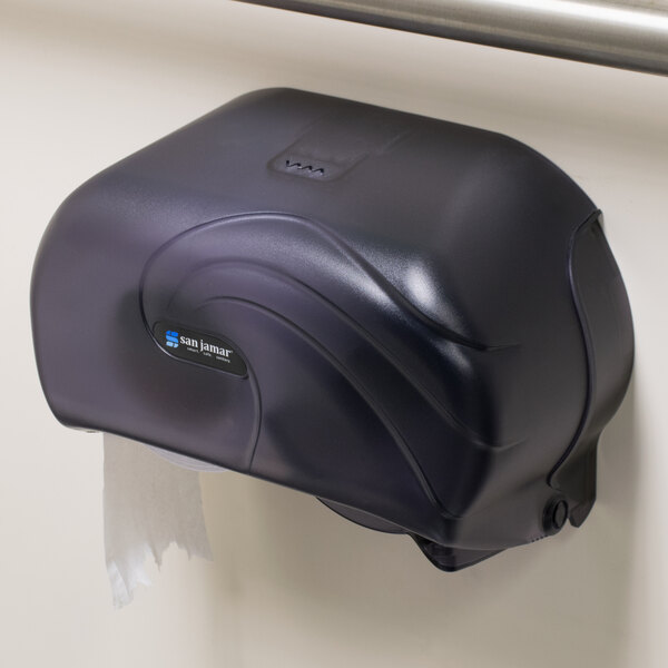 A black San Jamar Versatwin double roll toilet paper dispenser on a wall.