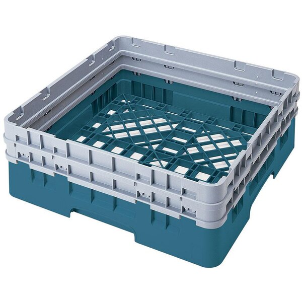 A teal plastic Cambro dish rack with closed sides and 2 extenders.