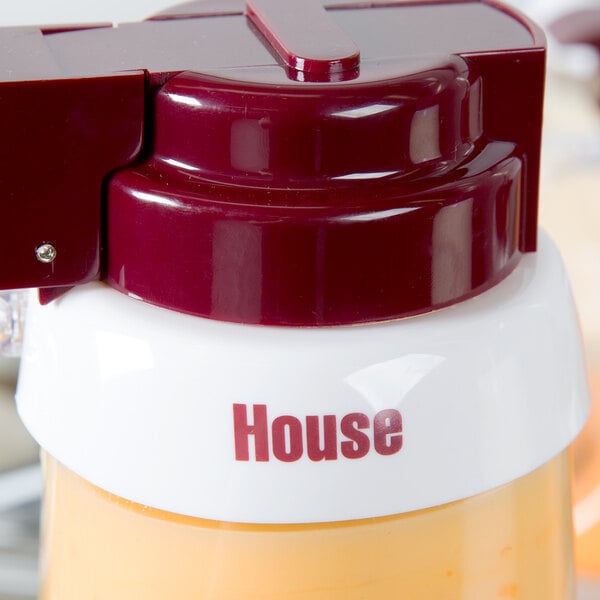 A Tablecraft plastic salad dressing dispenser collar with maroon lettering on a white container.