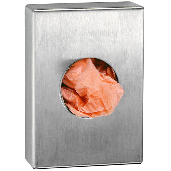 A stainless steel Bobrick sanitary disposal bag dispenser with a plastic bag in it.