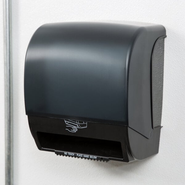 A black Response DISP 235 hands-free paper towel dispenser mounted on a white wall.