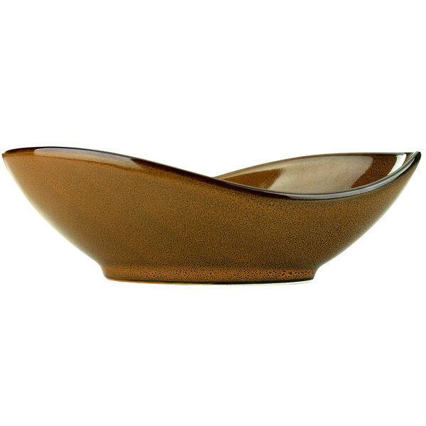 A close-up of a brown International Tableware Luna terracotta oval porcelain bowl with a speckled surface.
