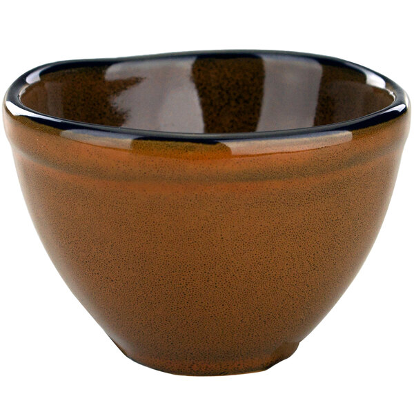 A terracotta bowl with a black rim.