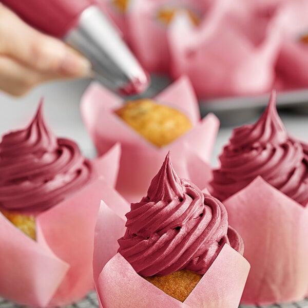 Chefmaster burgundy food coloring in pink frosting on a cupcake.