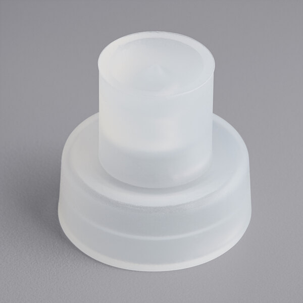 A close-up of a white silicone cup with a round top.