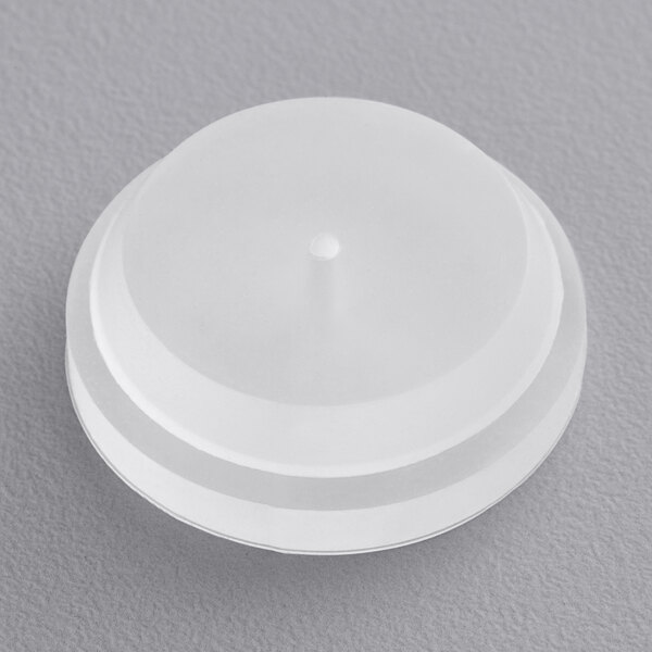 A white plastic lid with a point for a Bunn Replacement Thermostat Grommet.