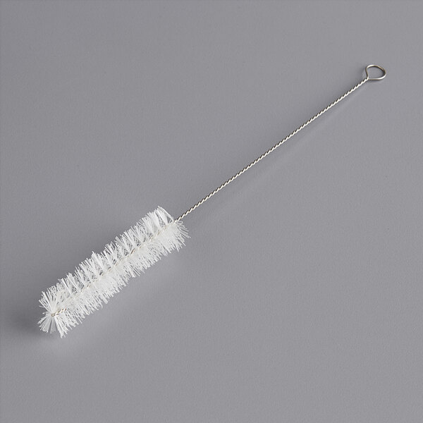 A white plastic brush with a silver metal handle.
