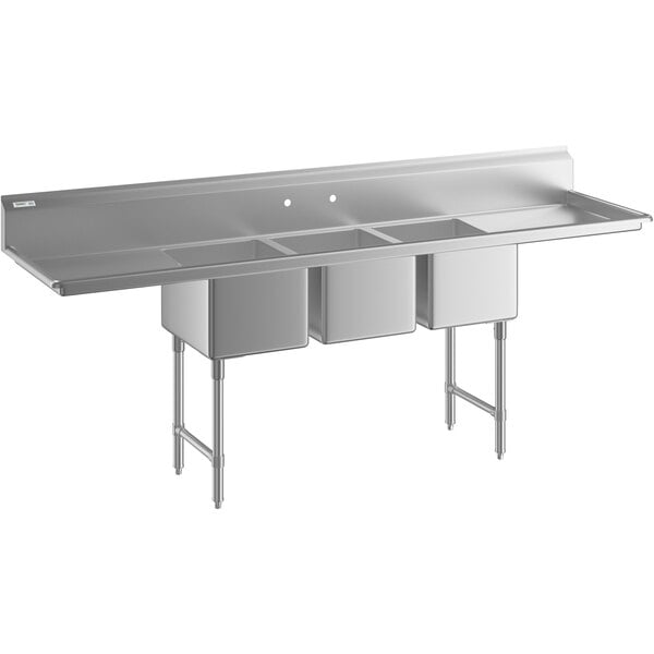 A Regency stainless steel three compartment sink with drainboards.