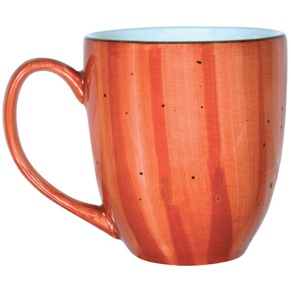 A close-up of a red International Tableware Bistro mug with speckled dots.