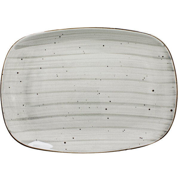 A white International Tableware rectangular porcelain platter with speckles on it.