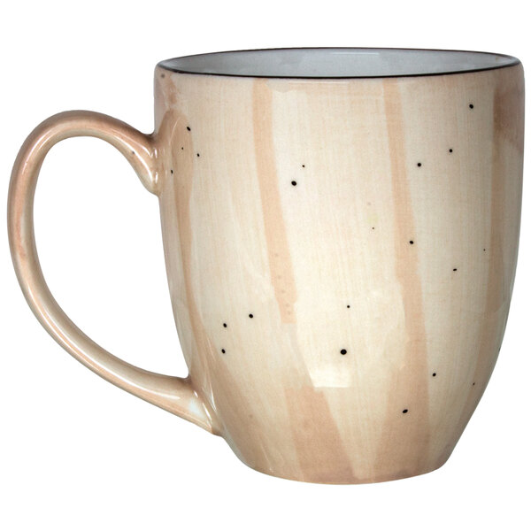 A close-up of the handle of a white Rotana wheat porcelain bistro mug with speckled dots.